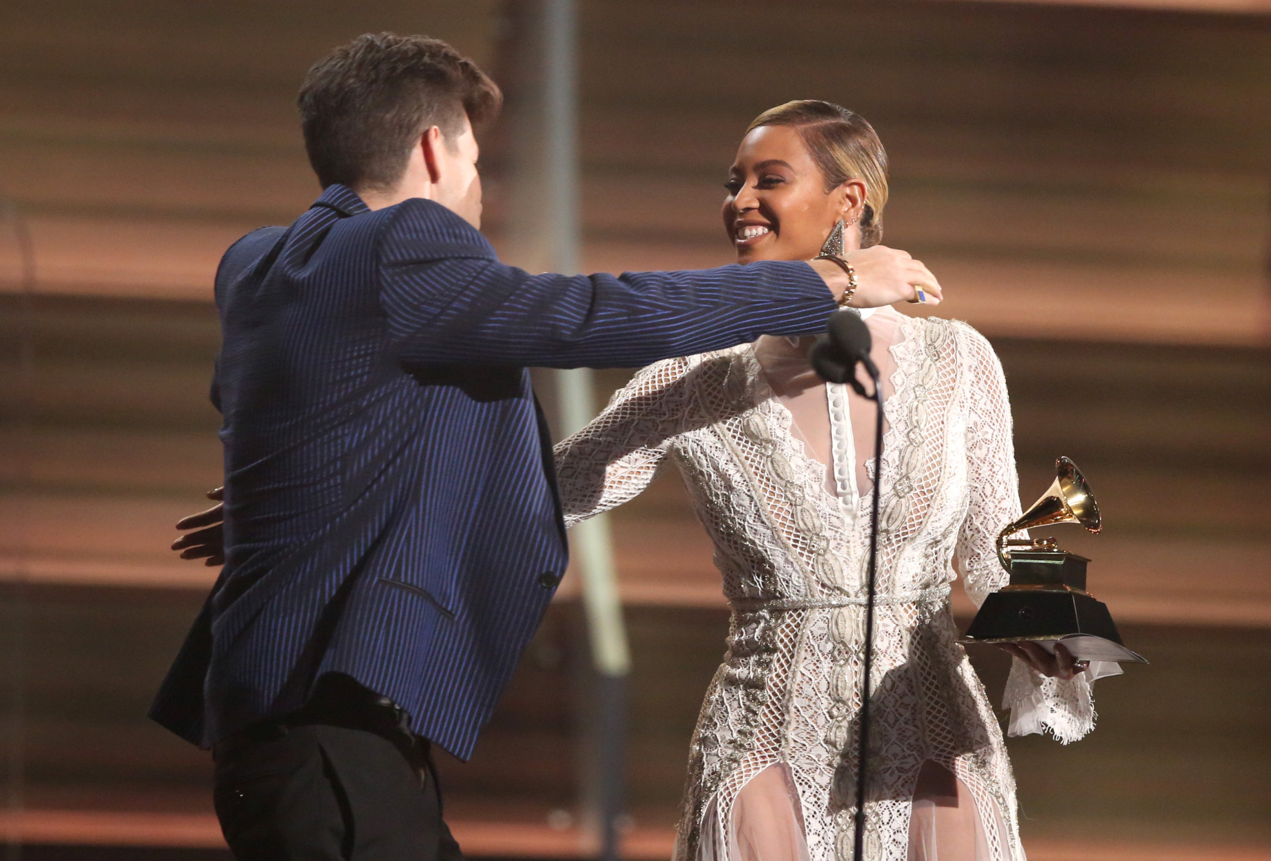 Beyonce, right, presents Mark Ronson with the award for record of the year for Uptown Funk at the 58th annual Grammy Awards on Monday, Feb. 15, 2016, in Los Angeles. (Photo by Matt Sayles/Invision/AP)