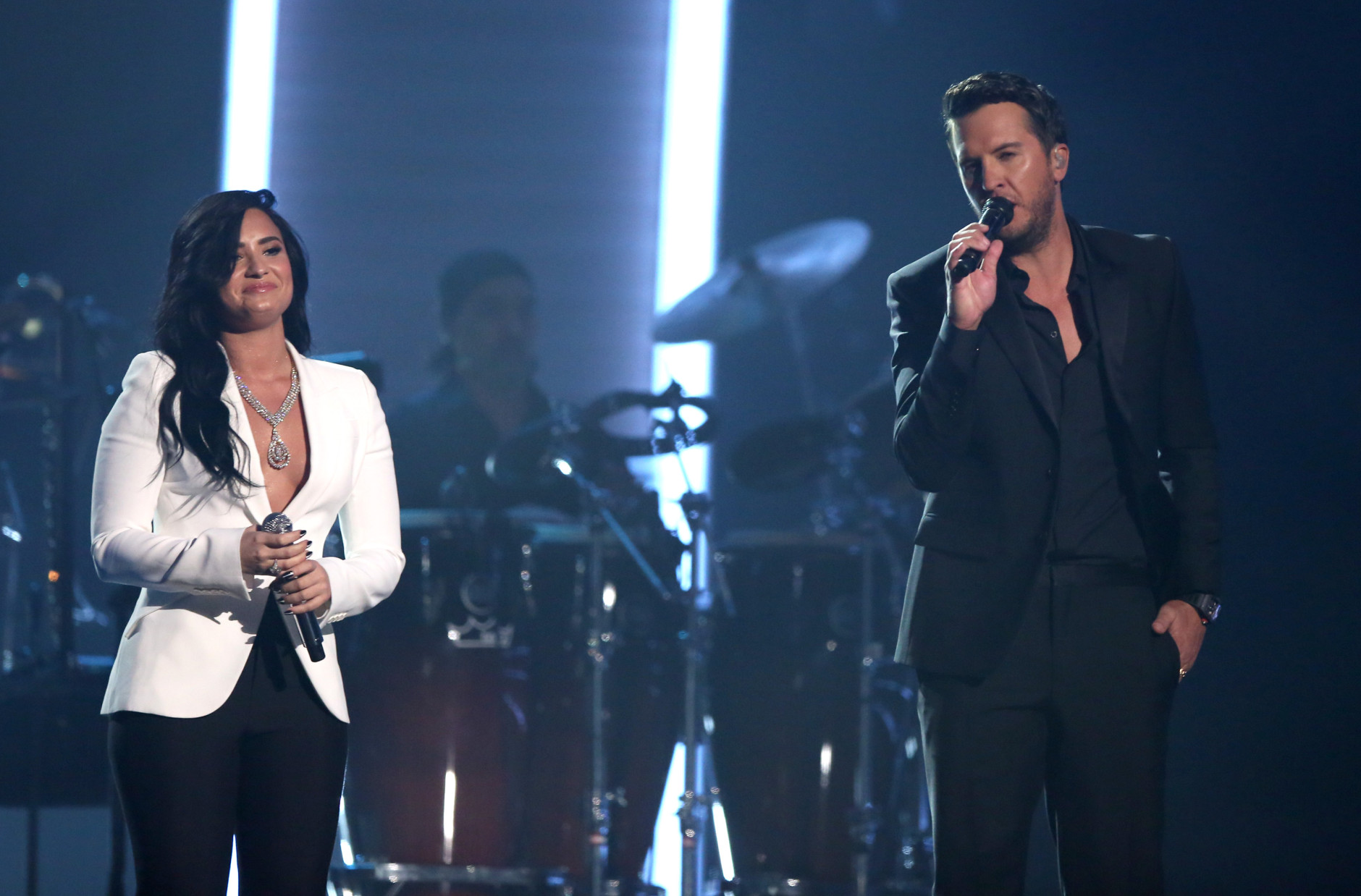 Demi Lovato, left, and Luke Bryan perform "Penny Lover" for a tribute to MusiCares Person of the Year honoree Lionel Richie at the 58th annual Grammy Awards on Monday, Feb. 15, 2016, in Los Angeles. (Photo by Matt Sayles/Invision/AP)