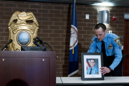 Prince William County Police Sgt. Jonathan L. Perok displays a picture of Officer Ashley Guindon before a news conference at Western District Station, in Manassas, Va., Sunday, Feb. 28, 2016. Ronald Williams Hamilton is being held without bond in the Prince William County Adult Detention Center on charges that include murder of a law enforcement officer. He is accused of shooting and killing Guindon after she and other officers answered a domestic violence call at the Hamilton home Saturday evening. (AP Photo/Jose Luis Magana)