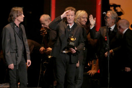 Don Henley, center, holds The Eagles' 1978 Grammy award for record of the year for Hotel California at the 58th annual Grammy Awards on Monday, Feb. 15, 2016, in Los Angeles. (Photo by Matt Sayles/Invision/AP)