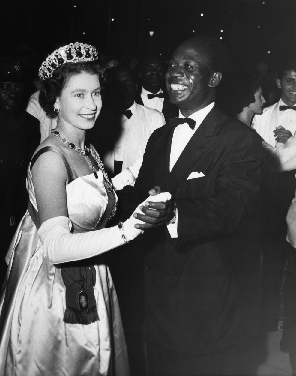 Queen Elizabeth II is partnered by Ghana President Kwame Nkrumah as they dance the popular Ghana rhythmic shuffle known as the "High Life" at a farewell ball given in honor of the Queen and her husband at the state house in Accra, Ghana at night on Saturday, Nov. 18, 1961. (AP Photo)