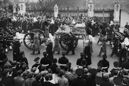 The funeral procession of Britain's King George VI begins its journey from Westminster Hall to Paddington Station, in London, on Feb. 15, 1952. Naval ratings from H.M.S. Excelllent draw the gun carriage bearing the coffin of the late king. The carriage is flanked by Gentlemen At Arms and Yeoman of the Guard. (AP Photo/Rider)