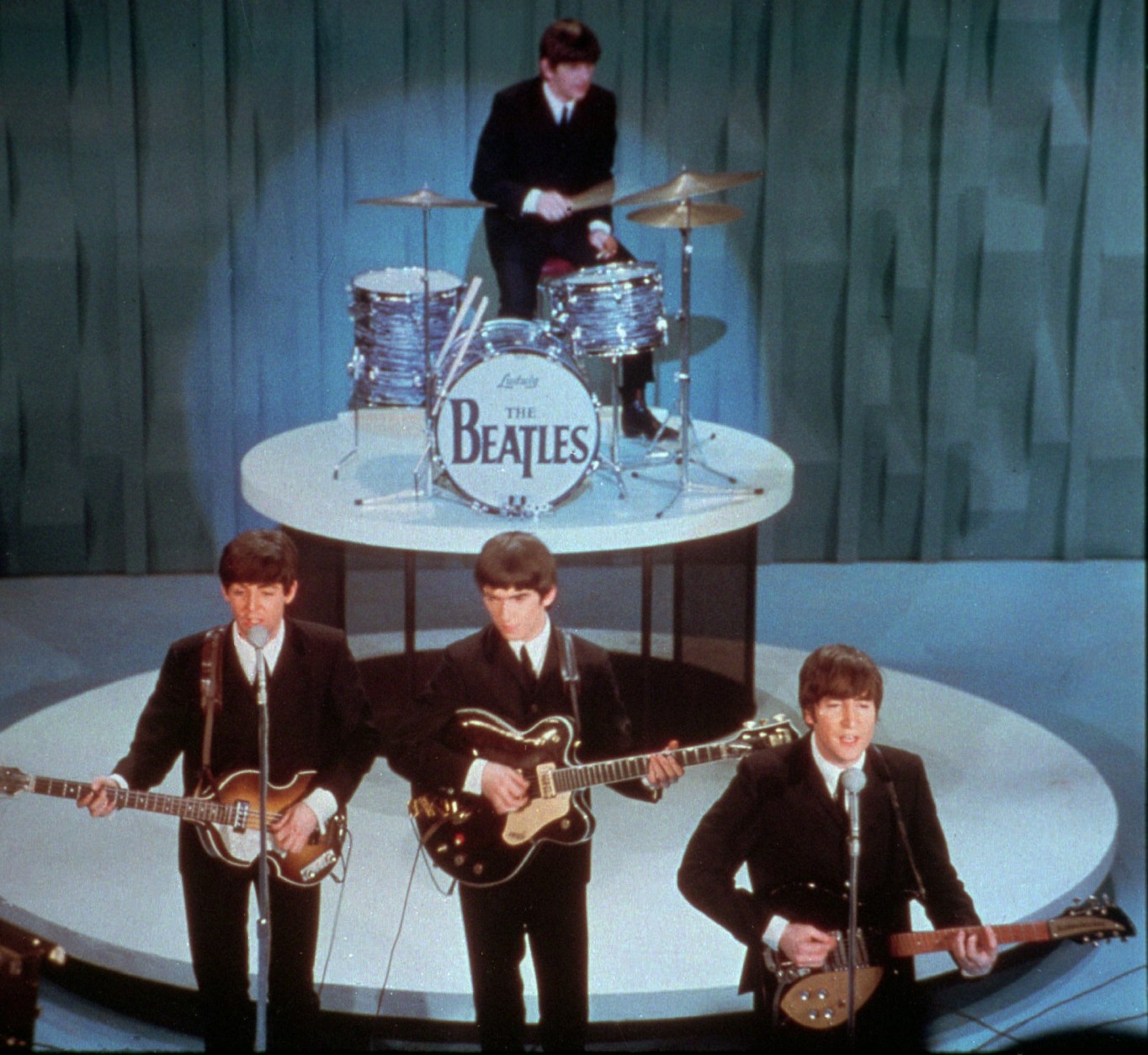 FILE - In this Feb. 9, 1964 file photo, The Beatles, front row from left, Paul McCartney, George Harrison, John Lennon and Ringo Starr on drums, perform at the "Ed Sullivan Show," in New York. BlueBeat.com has agreed to pay $950,000 to settle a lawsuit filed by the music companies EMI, Capitol Records and Virgin Records America after posting digital copies of The Beatles music a year before they became legitimately available. (AP Photo, file)