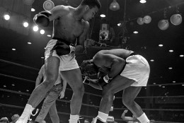 Sonny Liston, right, ducks low and weaves to escape a punch from Cassius Clay's cocked right fist during the 5th round of the heavyweight title fight in Miami Beach, Florida, February 25, 1964.  Clay won on a seventh round technical knockout. (AP Photo/stf)