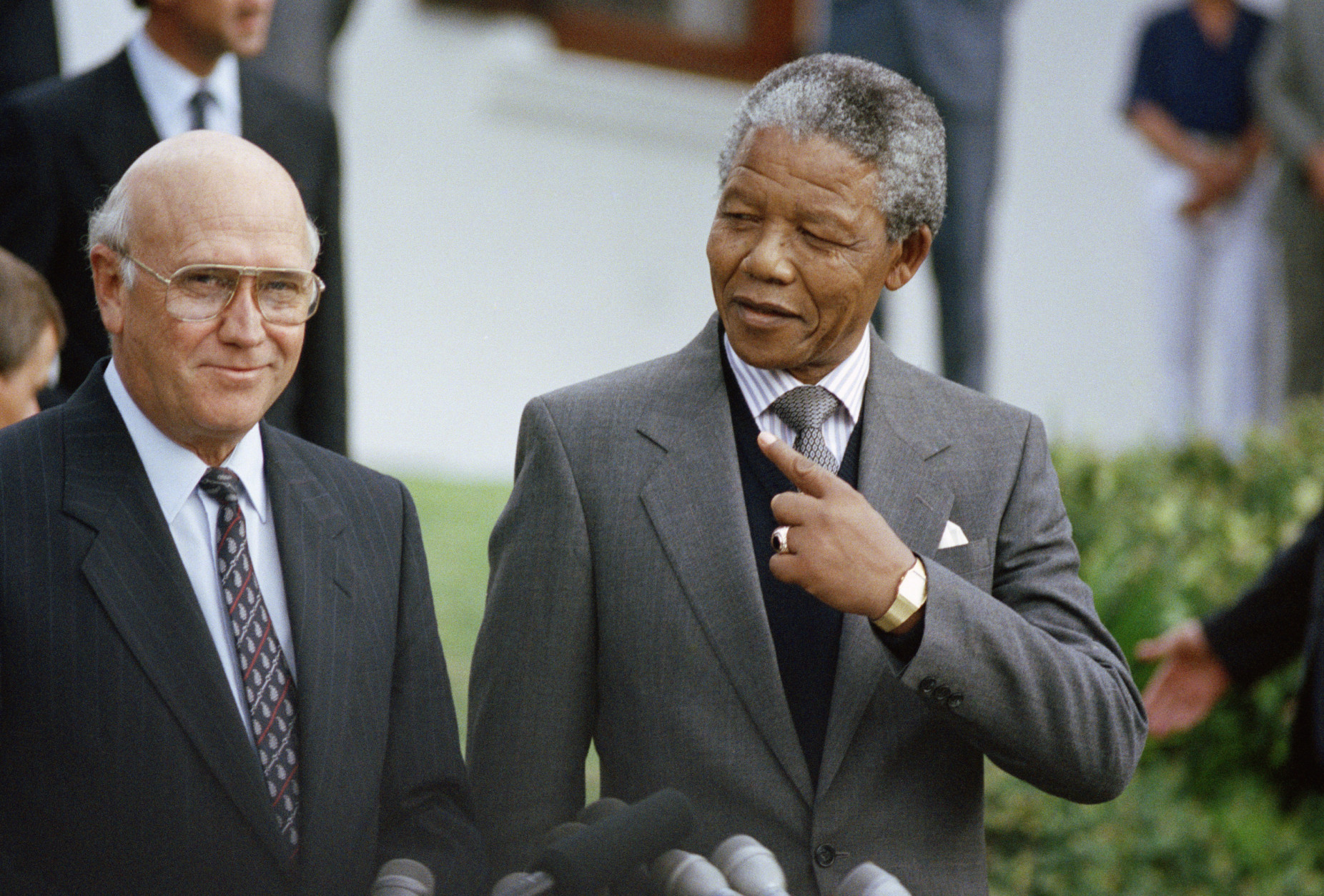 South African State President F W de Klerk, left,  and Deputy President of the African National Congress Nelson Mandela, right,  at a photocall on Wednesday, May 2, 1990 in Cape Town, South Africa, prior to meeting for talks which will last till Friday. (AP Photo/Denis Farrell)
