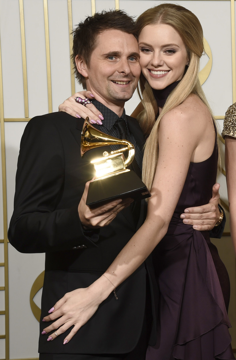 Matt Bellamy, left, of Muse poses in the press room with the award for best rock album for "Drones", and Elle Evans at the 58th annual Grammy Awards at the Staples Center on Monday, Feb. 15, 2016, in Los Angeles. (Photo by Chris Pizzello/Invision/AP)