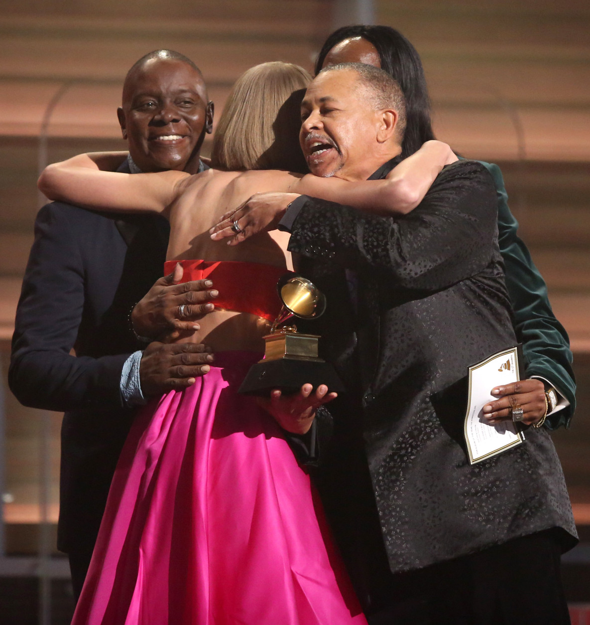 Philip Bailey, from left, Verdine White, obscured, and Ralph Johnson of Earth Wind &amp; Fire present Taylor Swift the award for album of the year for 1989 at the 58th annual Grammy Awards on Monday, Feb. 15, 2016, in Los Angeles. (Photo by Matt Sayles/Invision/AP)