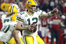 Green Bay Packers quarterback Aaron Rodgers (12) points to a receiver during the second half of an NFL divisional playoff football game against the Arizona Cardinals, Saturday, Jan. 16, 2016, in Glendale, Ariz. (AP Photo/Ross D. Franklin)