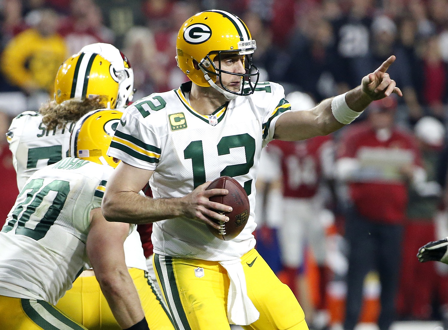 Green Bay Packers quarterback Aaron Rodgers (12) points to a receiver during the second half of an NFL divisional playoff football game against the Arizona Cardinals, Saturday, Jan. 16, 2016, in Glendale, Ariz. (AP Photo/Ross D. Franklin)