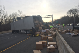 Boxes of clothes are littering the Outer Loop of the Beltway after a fata crash in the early morning of Feb. 19, 2016. (WTOP/Neal Augenstein)
