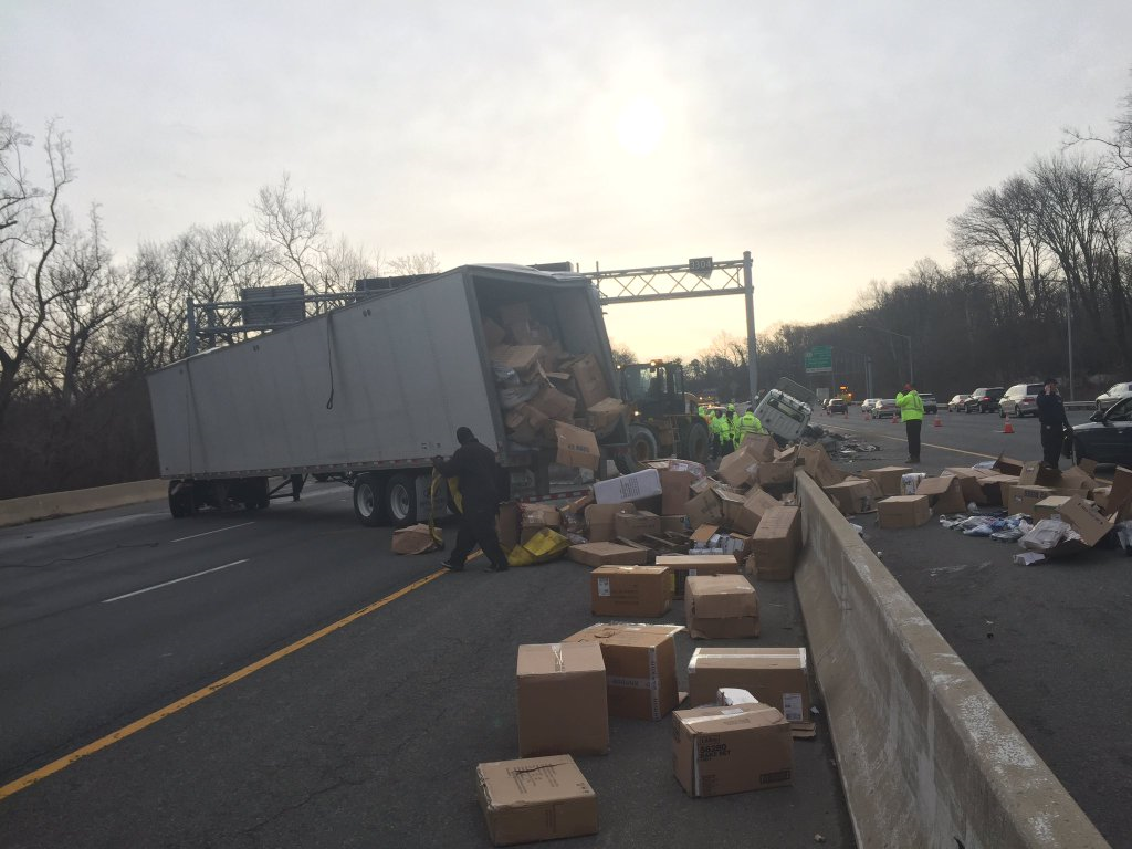 Boxes of clothes are littering the Outer Loop of the Beltway after a fata crash in the early morning of Feb. 19, 2016. (WTOP/Neal Augenstein)