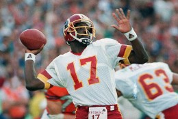 FILE - In this Jan. 31, 1988, file photo, Washington Redskins quarterback Doug Williams prepares to let go of a pass during first quarter of Super Bowl XXII against the Denver Broncos in San Diego. Williams, who set a record with 340 yards passing in the NFL football game and became the first African-American quarterback to win a Super Bowl. (AP Photo/Elise Amendola, File)