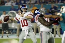 New York Giants quarterback Eli Manning (10) looks to pass during the first half of an NFL football game against the Miami Dolphins, Monday, Dec. 14, 2015, in Miami Gardens, Fla.  (AP Photo/Wilfredo Lee)