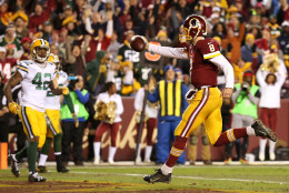 LANDOVER, MD - JANUARY 10: Quarterback Kirk Cousins #8 of the Washington Redskins scores a third-quarter touchdown against strong safety Morgan Burnett #42 of the Green Bay Packers during the NFC Wild Card Playoff game at FedExField on January 10, 2016 in Landover, Maryland. (Photo by Patrick Smith/Getty Images)