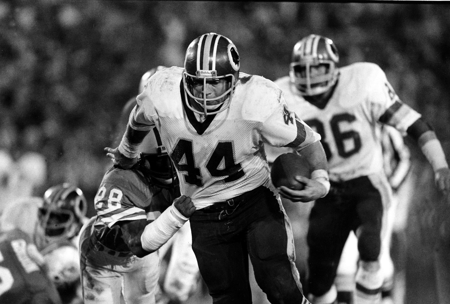 FILE -- This is a Jan. 30, 1983, file photo showing Washington Redskins running back John Riggins (44) eluding a tackle by Don McNeal (28), of the Miami Dolphins,  during Super Bowl XVII at the Rose Bowl in Pasadena, Calif. Clinton Portis is trying to be a bit more low key this year. Still, the Washington Redskins running back couldn't help but take a shot or two at the great John Riggins, whose franchise record Portis could break this year. (AP Photo/File)