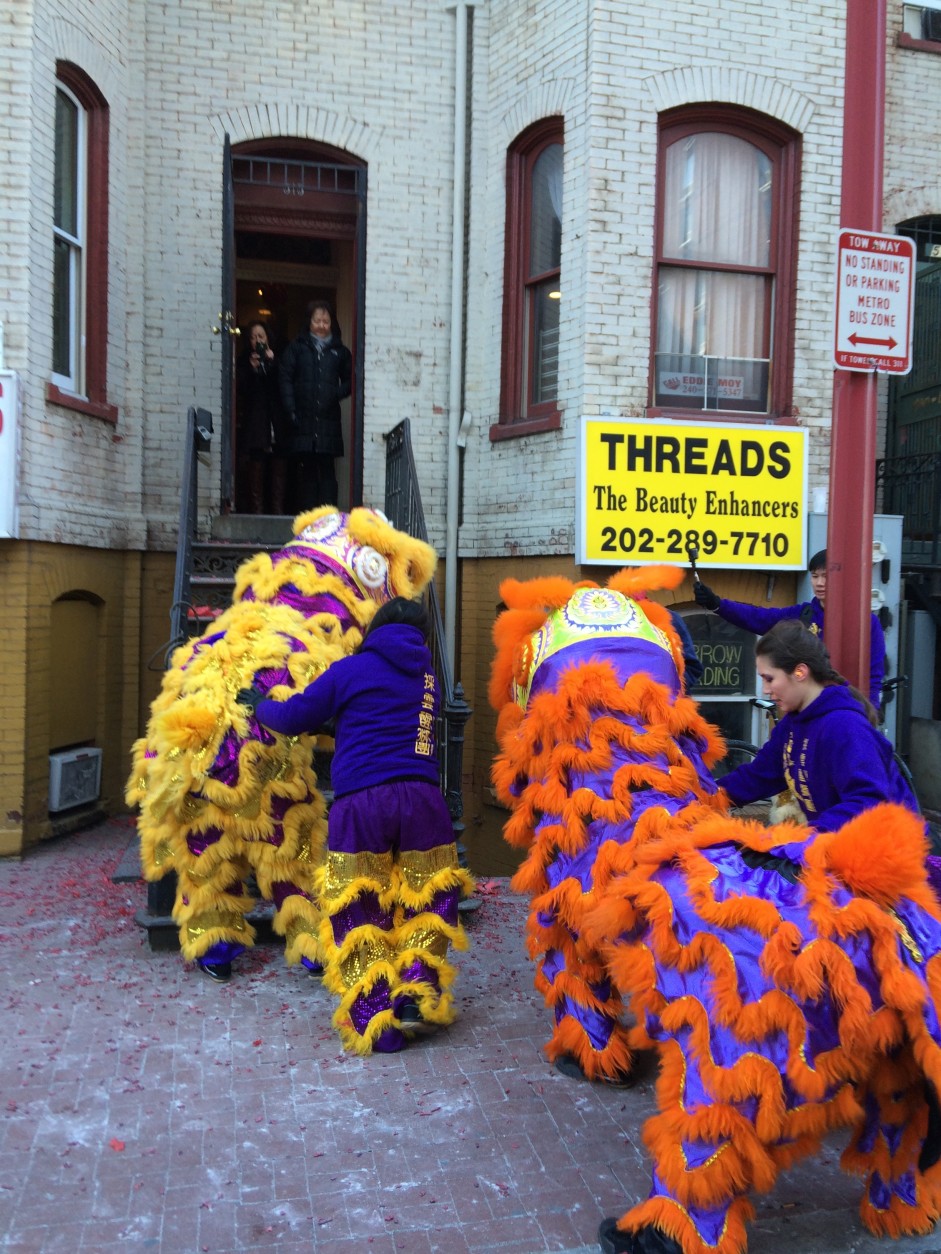 Lion dancers visit businesses in D.C.’s Chinatown on Friday, Feb. 14, 2016, in celebration of the Chinese New Year. (WTOP/Dick Uliano)