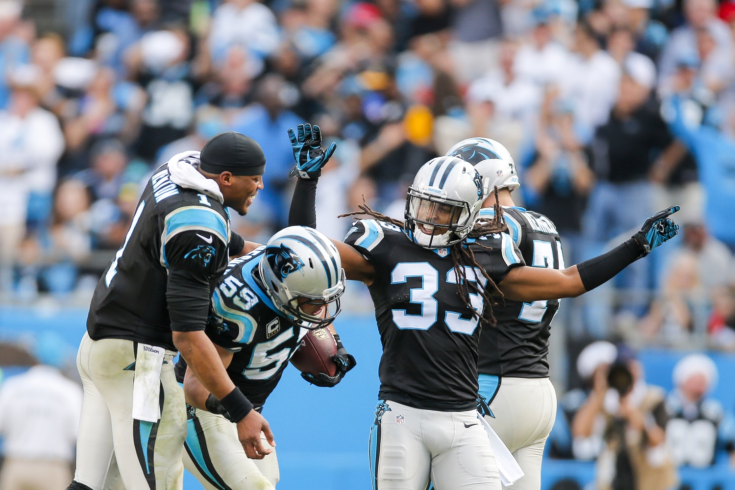 Carolina Panthers quarterback Cam Newton (1) celebrates with teammates middle linebacker Luke Kuechly (59) and free safety Tre Boston (33) after a interception against the Atlanta Falcons during an NFL football game at Bank of America Stadium in Charlotte, N.C. on Sunday, Dec. 13, 2015. (Chris Keane/AP Images for Panini)