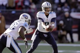 Tennessee Titans quarterback Marcus Mariota (8) hands off to running back Antonio Andrews (26) in the first half of an NFL football game against the New England Patriots, Sunday, Dec. 20, 2015, in Foxborough, Mass. (AP Photo/Charles Krupa)