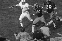FILE - In this Jan. 14, 1973, file photo, Washington Redskins' Mike Bass (41) runs toward the end zone for the only Redskins score, during the fourth quarter of the NFL football Super Bowl against the Miami Dolphins in Los Angeles.  Bass got the ball when field goal attempt by Dolphins' Garo Yepremian (1) was blocked and Yepremian attempted to pass. At right is Redskins' Ted Vactor. (AP Photo/File)
