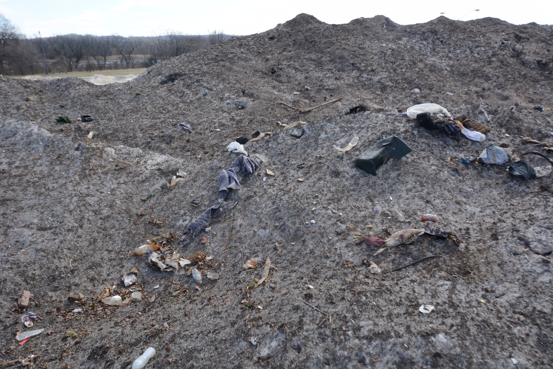 The tallest piles of snow and trash are about 20 feet high after some melting last week. This week's cold temperatures will likely freeze these icy landfills in place.  (WTOP/Dave Dildine)