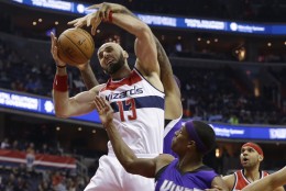Washington Wizards center Marcin Gortat (13) fights for control of the ball with Sacramento Kings forward DeMarcus Cousins, rear, and guard Rajon Rondo during the first half of an NBA basketball game Monday, Dec. 21, 2015, in Washington. Wizards forward Jared Dudley is at right. (AP Photo/Carolyn Kaster)