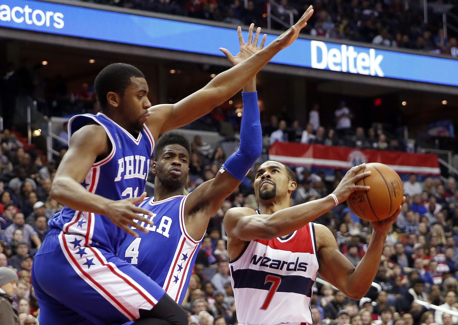 Philadelphia 76ers guard Hollis Thompson, left, and forward Nerlens Noel (4) defend Washington Wizards guard Ramon Sessions (7) during the second half of an NBA basketball game, Friday, Feb. 5, 2016, in Washington. The Wizards won 106-94. (AP Photo/Alex Brandon)