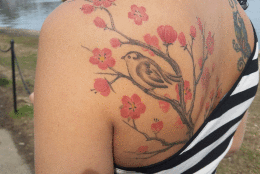Brazilian visitor 'Andrea' shows off her Cherry Blossom tattoo (WTOP/Kathy Stewart)