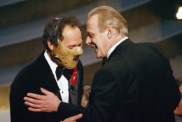 Oscar host Billy Crystal dons a Hannibal the Cannibal mask, left, in the audience with Anthony Hopkins at the 64th Annual Academy Awards Monday, March 30, 1992 in Los Angeles. Hopkins is nominated for Actor in a leading role for his portrayal of Dr.  Hannibal Lecter in "The Silence of the Lambs." (AP Photo/Craig Fujii)