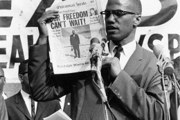 Black Muslim leader Malcolm X holds up a paper for the crowd to see during a Black Muslim rally in New York City on Aug. 6, 1963. (AP Photo)
