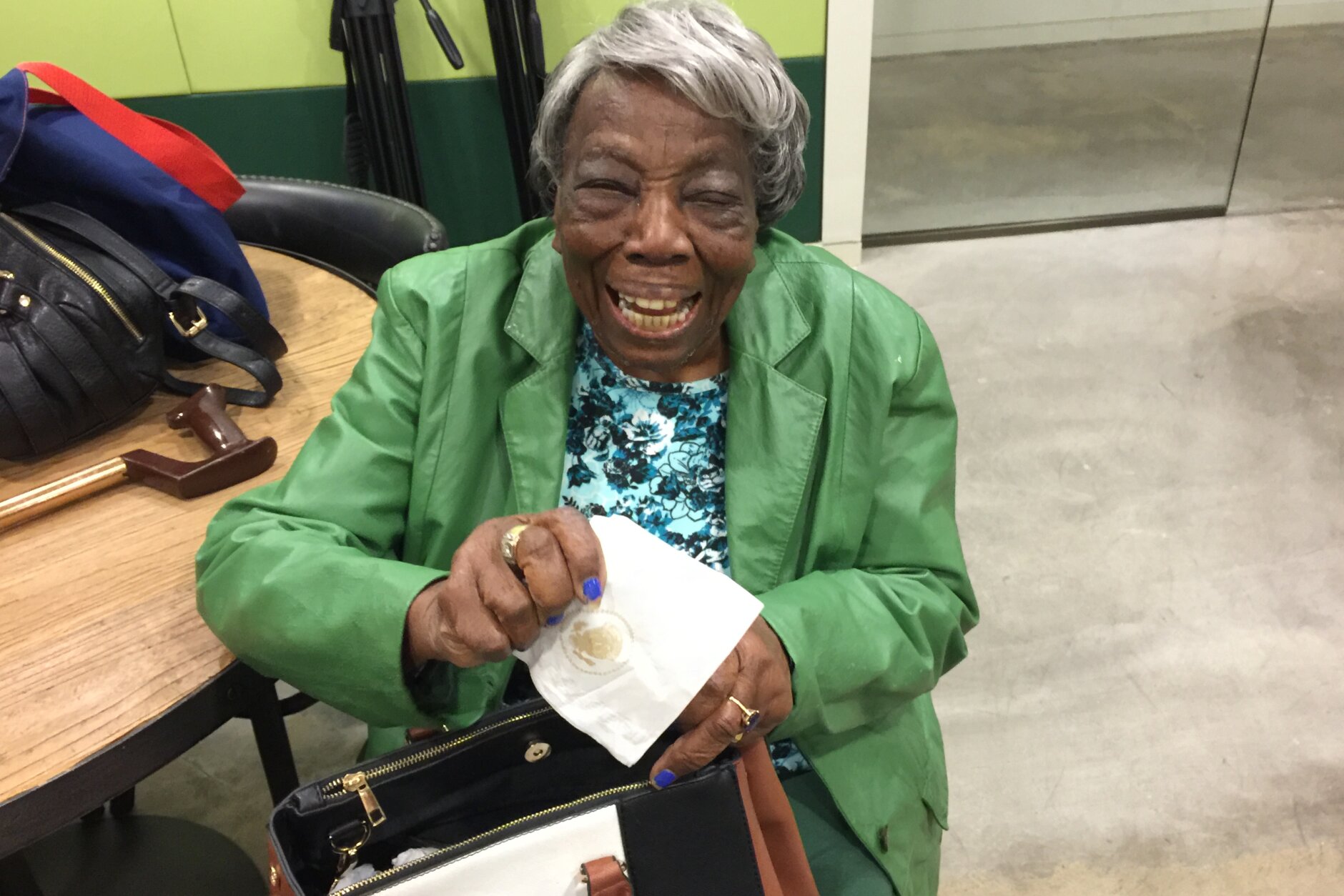 Virginia McLaurin displays the White House napkin she got when meeting President Obama and the First Lady. Video of the 106-year-old dancing with the first couple garnered (at publication) 59,570,733 views on the White House Facebook page. (WTOP/Kristi King)