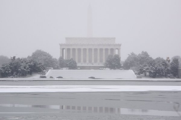 The Washington Monument is barely visible behind the Lincoln Memorial on Monday, Feb. 15, 2016 as a storm moved through the D.C. region . (WTOP/Dave Dildine via Twitter)