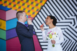 Kendra and Joel had their ceremony in front of a mural in Crystal City, Virginia. (Courtesy Pop! Wed Co.)
