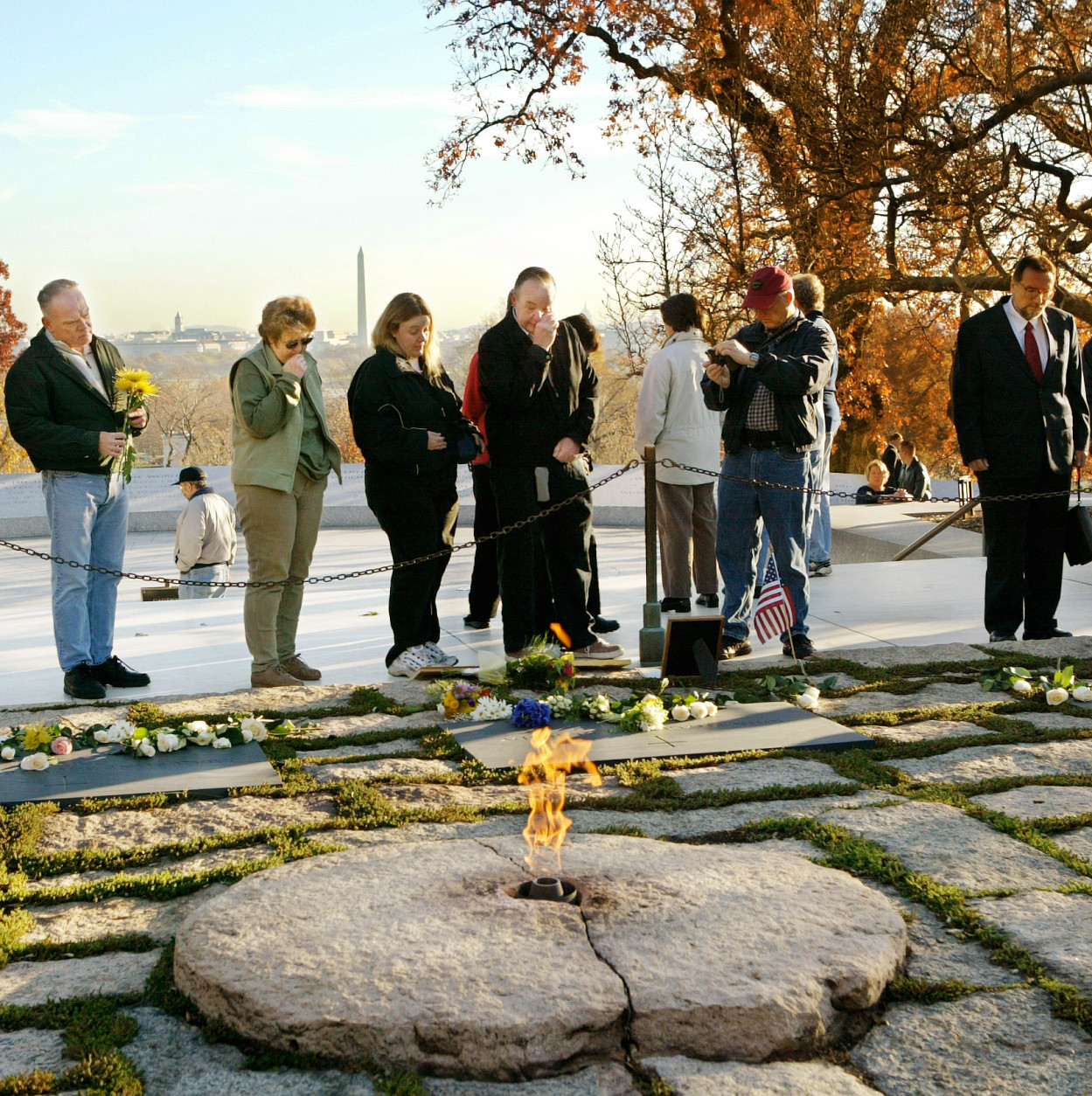On the 40th anniversary of the assassination of President John F. Kennedy in Dallas, visitors pay their respects at Kennedy's gravesite in Arlington National Cemetery in Arlington, Va., Saturday, Nov. 22, 2003. Members of the slain president's family visited in private at dawn before the cemetery was opened to the public.  (AP Photo/J. Scott Applewhite)