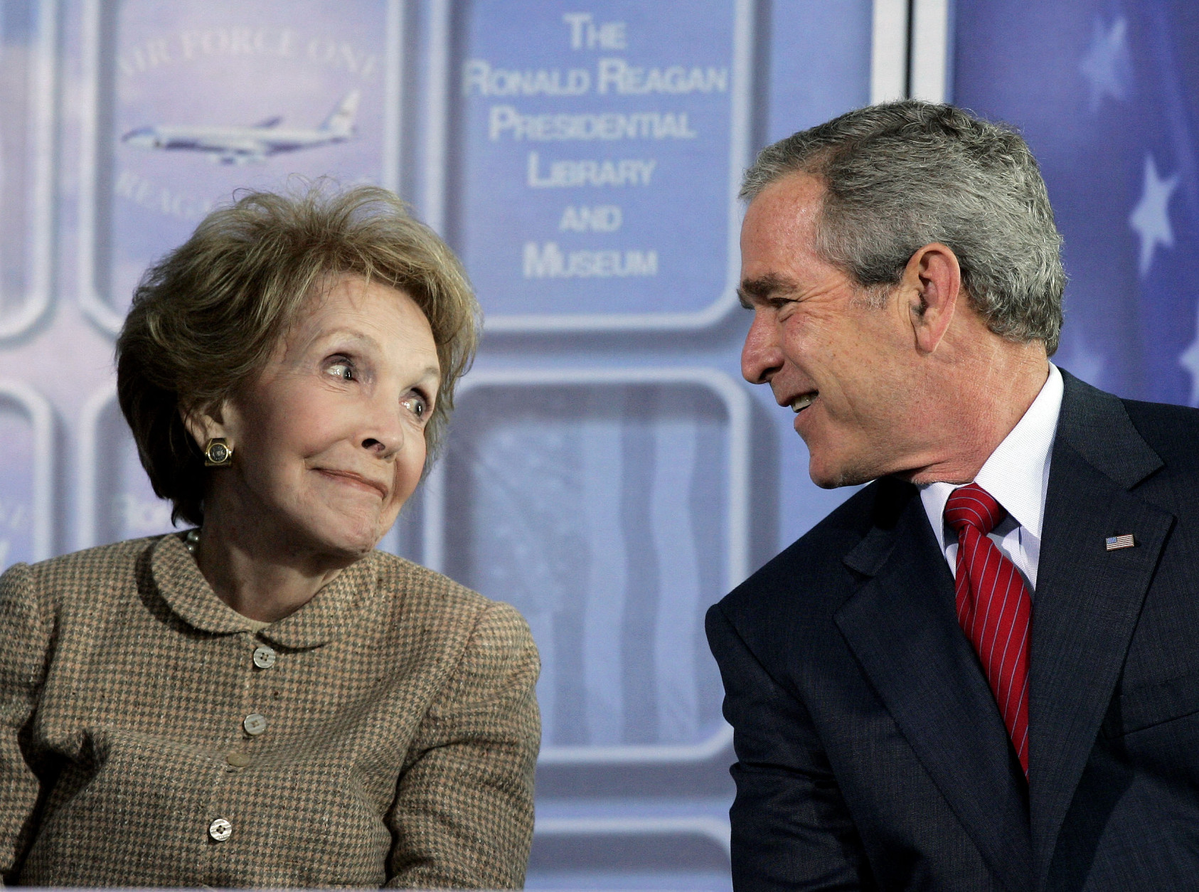 President Bush exchange glances with former first lady Nancy Reagan during dedication ceremonies for the retired Air Force One Boeing 707 aircraft at the  Ronald Reagan Presidential Library and Museum in Simi Valley, Calif., Friday, Oct. 21, 2005. (AP Photo/Kevork Djansezian)