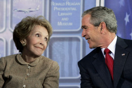 President Bush exchange glances with former first lady Nancy Reagan during dedication ceremonies for the retired Air Force One Boeing 707 aircraft at the  Ronald Reagan Presidential Library and Museum in Simi Valley, Calif., Friday, Oct. 21, 2005. (AP Photo/Kevork Djansezian)