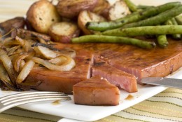 Ham steaks are a quick and versatile way to get a ham dinner on the plate. These maple ham steaks with roasted potatoes and green beans require very little prep and are an elegant choice for your Easter meal. (AP Photo/Larry Crowe)