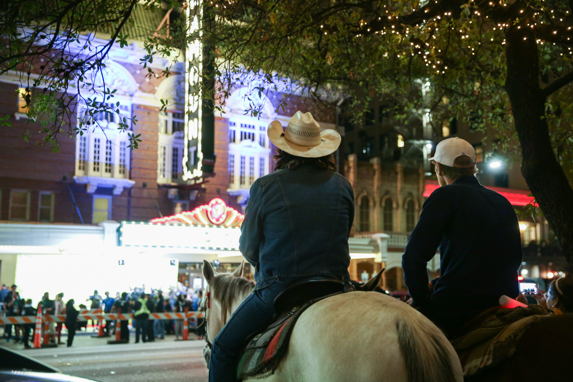Men on horseback watch a film premiere taking place during South By Southwest on Saturday, March 12, 2016, in Austin, Texas. (Photo by Rich Fury/Invision/AP