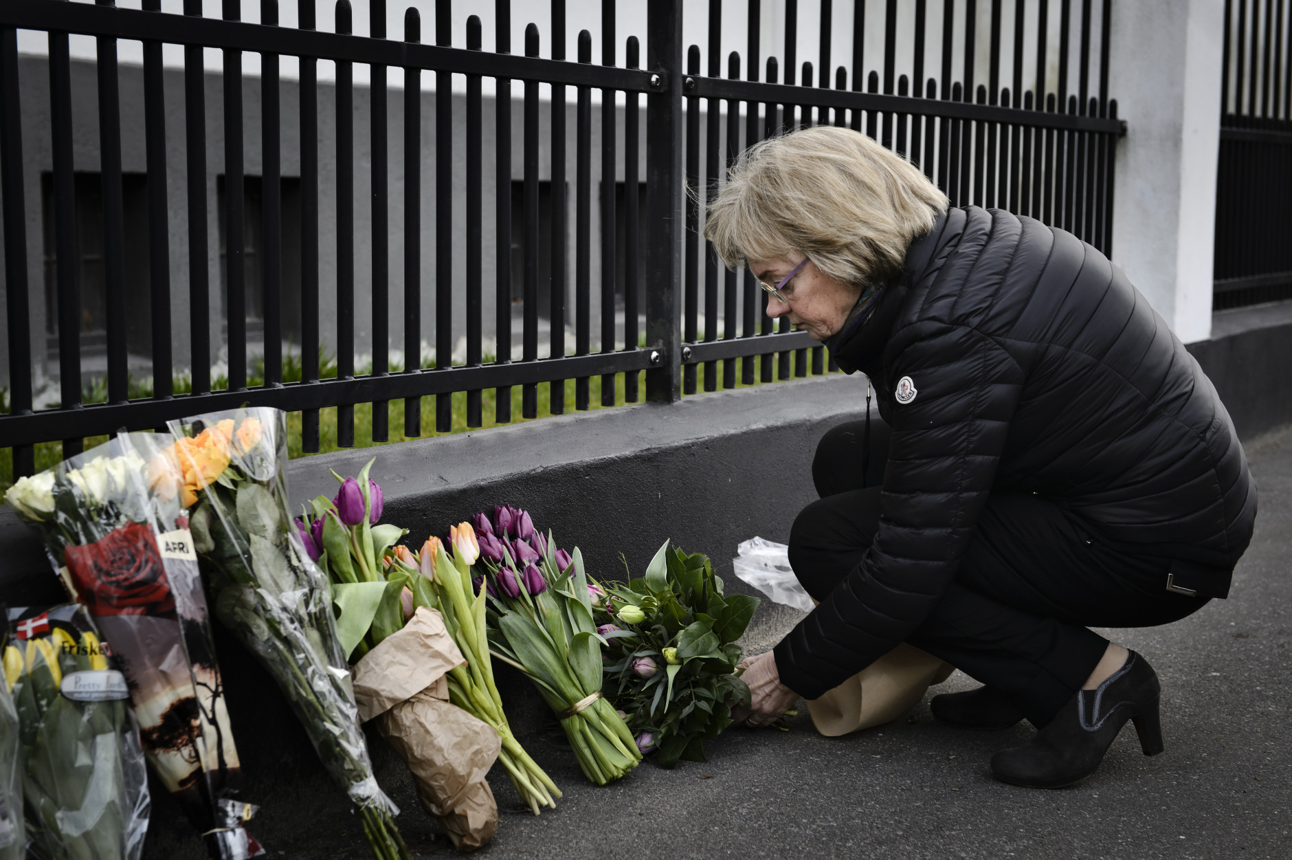 Chairman of the Danish Parliament, Pia Kjaersgaard, with flowers for the victims of the Brussels attacks, at the Belgium Embassy in Copenhagen Tuesday, March 22, 2016. Bombs exploded at the Brussels airport and one of the city's metro stations Tuesday, killing and wounding dozens of people, as a European capital was again locked down amid heightened security threats. The Islamic State group claimed responsibility for the attacks. (Philip Davali/POLFOTO via AP)  DENMARK OUT