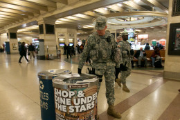 New York Army National Guard Staff Sgt. Rueter, foreground, of Joint Task Force Empire Shield, patrols the lower concourse of Grand Central Terminal, in New York,  Tuesday, March 22, 2016. Authorities are increasing security throughout New York City following explosions at the airport and subway system in the Belgian capital of Brussels.  (AP Photo/Richard Drew)