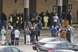 Police and rescue officials gather outside the Greyhound Bus Station Thursday, March 31, 2016, in Richmond, Va. Virginia State Police say two troopers responding to a shooting at the Richmond bus station and a civilian have been taken to a hospital. A police spokeswoman says the shooting suspect was in custody. (AP Photo/Steve Helber)