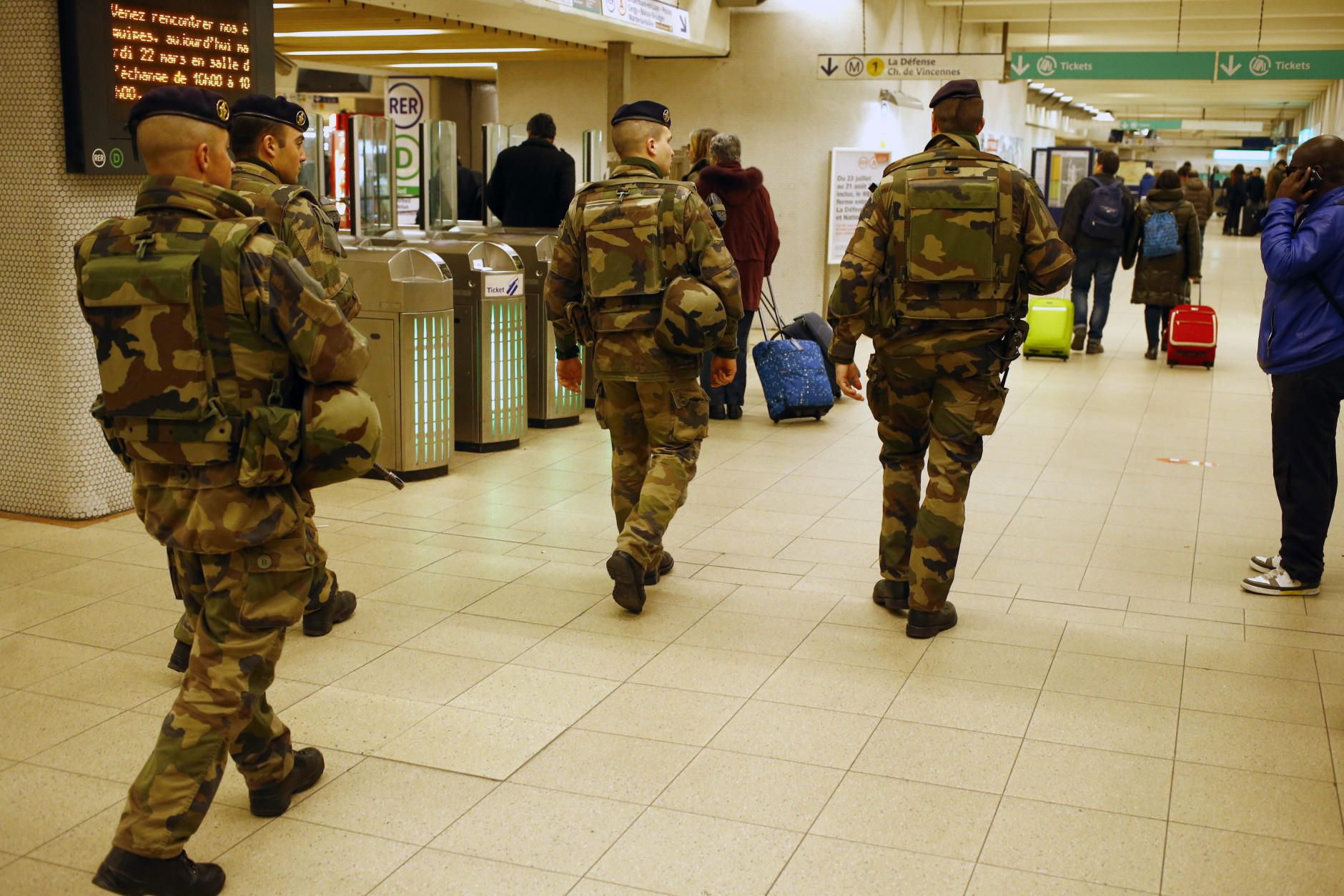 French soldiers patrol in the subway entrance station in Paris, France, Tuesday, March 22, 2016. Authorities are tightening security at airports and on the streets of European cities after attacks on the Brussels airport and subways system that killed at least one person and injured many others. (AP Photo/Francois Mori)