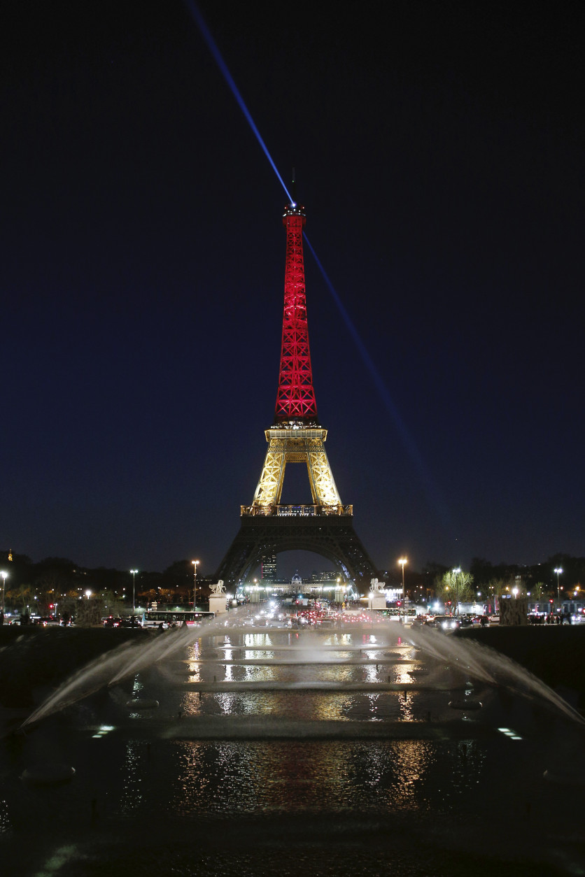 The Eiffel Tower is illuminated with the Belgium national colors black, yellow and red in honor of the victims of the today's attacks at the airport and the metro station in Brussels, in Paris, Tuesday, March 22, 2016. Explosions, at least one likely caused by a suicide bomber, rocked the Brussels airport and its subway system Tuesday, prompting a lockdown of the Belgian capital and heightened security across Europe. (AP Photo/Thibault Camus)