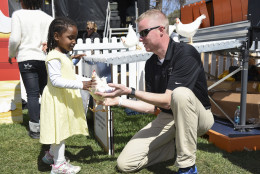 A young girl learns about egg farming at the American Egg Board's Farm To Table exhibit at the White House Easter Egg Roll on the White House South Lawn in Washington, Monday, March 28, 2016. (Kevin Wolf/AP Images for American Egg Board)