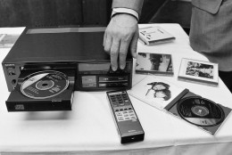 Sony's compact digital audio disc, 4.75-inches in diameter, is loaded into a laser disc cd player during a demonstration for the press in Tokyo, Japan, Aug. 31, 1982. The system, developed by Sony with the Dutch Philips, uses a laser beam to read the music on the compact disc, on which information is stored digitally. No conventional stylus is used. The manufacturer claims superior sound reproduction. It will appear on the Japanese market in October at about $700, an in the U.S. and Europe market a year later. In the foreground is a remote control unit for the player. (AP Photo/Katsumi Kasahara)