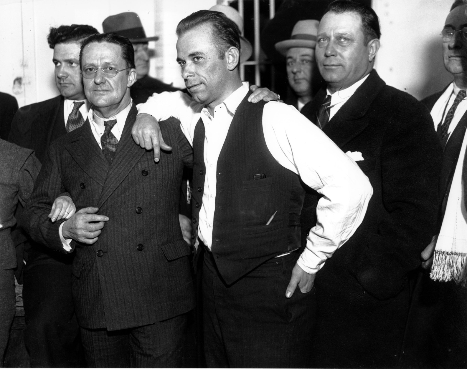 Gangster John Dillinger, center, strikes a pose with Lake County prosecuter Robert Estill, left, in the jail at Crown Point, Indiana, in 1934.  Dillinger is awaiting trial for the murder of police officer Willliam Patrick O'Malley when Dillinger robbed the First National Bank of East Chicago on Jan. 15, 1934.  (AP Photo)