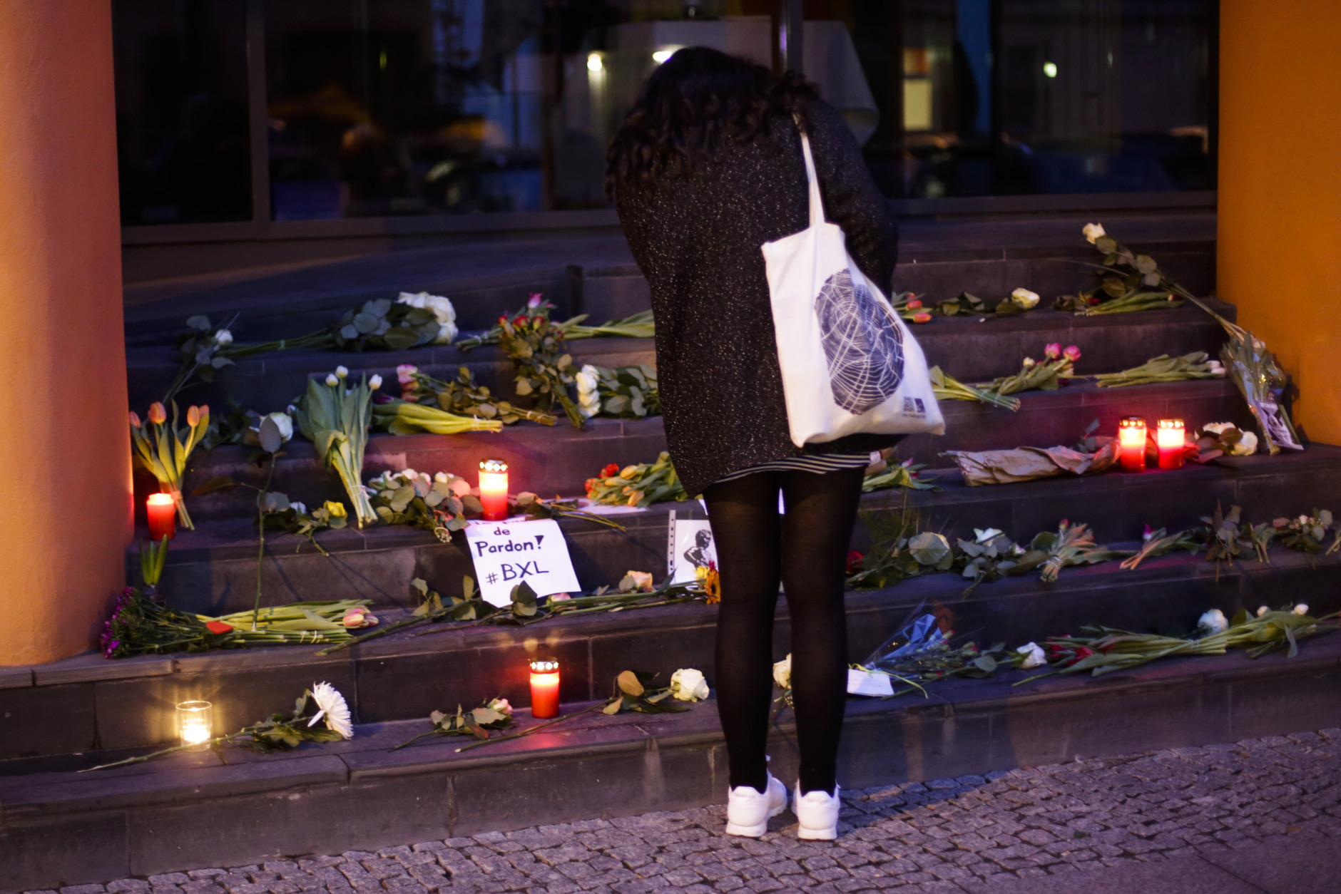 A woman lays flowers in front of the Belgium Embassy in Berlin, Germany, Tuesday, March 22, 2016, after Tuesday's terrorist attacks in Brussels. (AP Photo/Markus Schreiber)