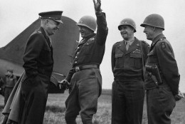 General George Patton, Commander of the Third U.S. Army, arm raised, amuses General Dwight Eisenhower during the Supreme Commanders tour of the western fronts on March 28, 1945. Lieutenant General Courtney Hodges, commander First U.S. Army, second right, and General Omar Bradley, commander of 12th Army group watch. (AP Photo)