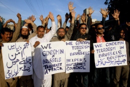Activists of Pakistani civil society chant slogans during a rally to condemn the Brussels attack, in Multan, Pakistan, Tuesday, March 22, 2016. Explosions, at least one likely caused by a suicide bomber, rocked the Brussels airport and subway system Tuesday, prompting a lock down of the Belgian capital and heightened security across Europe. Placard at left reads, "we want peace in the world." (AP Photo/Asim Tanveer)