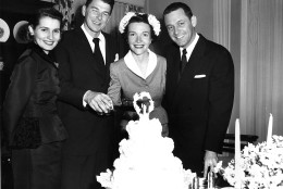 Actor Ronald Reagan and his bride, actress Nancy Davis, cut their wedding cake after their marriage at the non-sectarian Little Brown Church of the Valley in North Hollywood, Ca., March 4, 1952.  With them are actress Brenda Marshall, left, and her husband, actor William Holden.  (AP Photo)