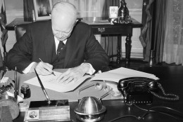 President Dwight  Eisenhower signs the bill to make Hawaii the 50th State at the White House on March 17, 1959 in Washington. The chief executive used several pens in placing his signature on the measure. (AP Photo/Charles Gorry)